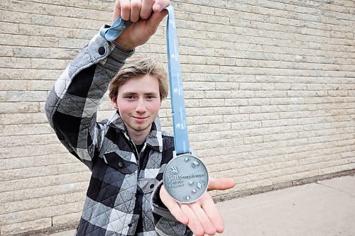 Mathew Kuszak, a Grade 12 student at Crocus Plains Regional Secondary School, displays his silver medal for autobody repair from the 2024 Skills Canada National Competition in Quebec City. (Tim Smith/The Brandon Sun)
