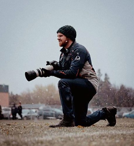 Canada West selected Brandon Sun sports reporter Thomas Friesen as the 2024 recipient of the Fred ‘Gus’ Collins Award. Here, Friesen is seen on the sidelines on a snowy day photographing a sports event. (Photo courtesy Jake Thiessen)