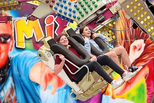 Loughlan McMullan and Veronika Hrytsenko ride the Re-Mix on the midway during the opening evening of the Manitoba Summer Fair at the Keystone Centre on Wednesday. See more photos on Page A4. (Tim Smith/The Brandon Sun)
