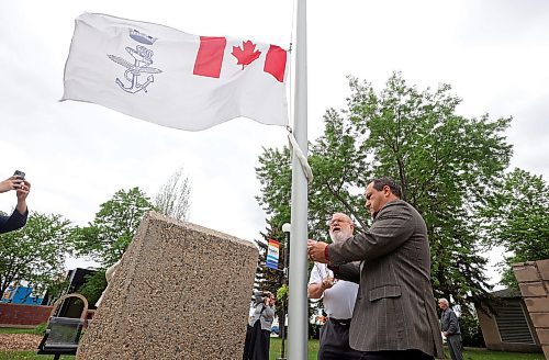 George Haggerty with Brandon Salutes and Brandon City Councillor and acting mayor Jason Splett raise the Royal Canadian Navy ensign at city hall on Wednesday in honour of the city’s namesake ship HMCS Brandon’s 25 years of service. (Tim Smith/The Brandon Sun)