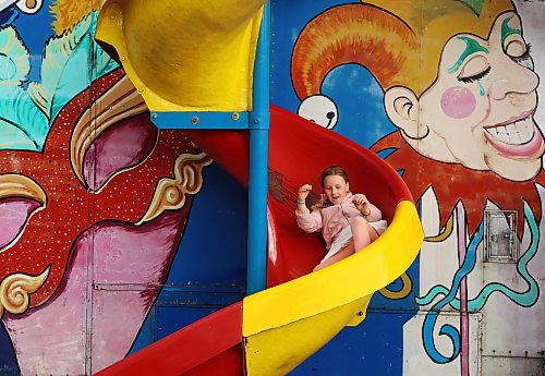 Seven-year-old Brenley Burns slides down a funhouse slide. (Tim Smith/The Brandon Sun)