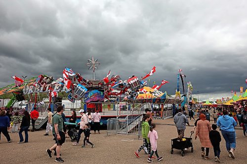 05062024
Fair-goers aren&#x2019;t deterred by the storm clouds as they take in the opening evening of the Manitoba Summer Fair at the Keystone Centre on Wednesday. The fair runs until Sunday.
(Tim Smith/The Brandon Sun)