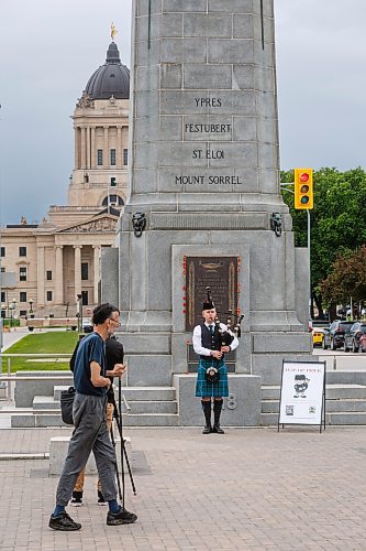 MIKE DEAL / FREE PRESS
Ethan Blain, Pipe Major of the Lord Selkirk Robert Fraser Memorial Pipe Band, in front of the Cenotaph on Memorial Boulevard, performs with his bagpipes in memory of the Normandy Landings of D-Day that took place 80 years ago on June 6th, 1944. 
240606 - Thursday, June 06, 2024.