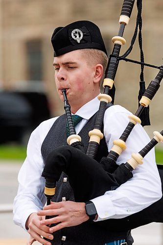 MIKE DEAL / FREE PRESS
Ethan Blain, Pipe Major of the Lord Selkirk Robert Fraser Memorial Pipe Band, in front of the Cenotaph on Memorial Boulevard, performs with his bagpipes in memory of the Normandy Landings of D-Day that took place 80 years ago on June 6th, 1944. 
240606 - Thursday, June 06, 2024.