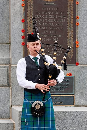 MIKE DEAL / FREE PRESS
Ethan Blain, Pipe Major of the Lord Selkirk Robert Fraser Memorial Pipe Band, in front of the Cenotaph on Memorial Boulevard, performs with his bagpipes in memory of the Normandy Landings of D-Day that took place 80 years ago on June 6th, 1944. 
240606 - Thursday, June 06, 2024.