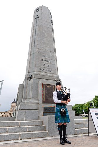 MIKE DEAL / FREE PRESS
Ethan Blain, Pipe Major of the Lord Selkirk Robert Fraser Memorial Pipe Band, in front of the Cenotaph on Memorial Boulevard, performs with his bagpipes in memory of the Normandy Landings of D-Day that took place 80 years ago on June 6th, 1944. 
240606 - Thursday, June 06, 2024.