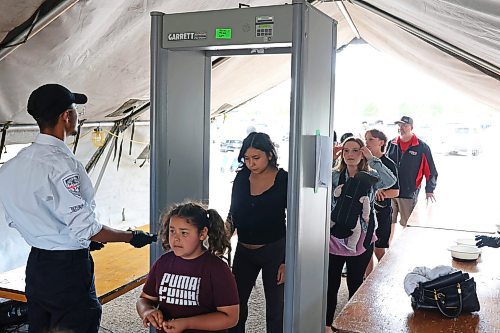 Visitors to the Manitoba Summer Fair on Friday pass through a metal detector as part of increased security for the fair at the Keystone Centre grounds. Security guards also checked fairgoers' bags before they could enter. (Tim Smith/The Brandon Sun)