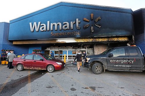 Crews begin work to clean up after an early-morning fire was set outside the Walmart shopping centre in Brandon's Corral Centre on Friday morning. The fire quickly spread to the structure, which suffered extensive smoke and water damage to its front entrance. Walmart was closed to customers as a result on Friday. (Matt Goerzen/The Brandon Sun)