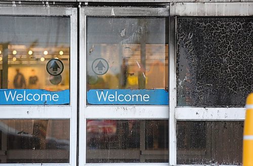 Scorched glass doors mark the entrance of Brandon's Walmart shopping centre at the Corral Centre on Friday, after an early-morning fire was set to an adirondack chair outside the building. The fire soon spread to the building and damaged the exterior. (Matt Goerzen/The Brandon Sun)