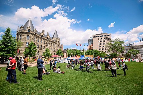 Mike Sudoma/Free Press
Supporters and members of the media listen while encampment resident who goes by the alias of Kat speaks  in front of the encampments at the University of Winnipeg Friday
June 7, 2024