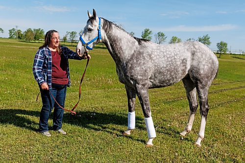 MIKE DEAL / FREE PRESS
Explosive with trainer Lise Pruitt at Assinboia Downs Friday morning.
See George Williams story
240607 - Friday, June 07, 2024.