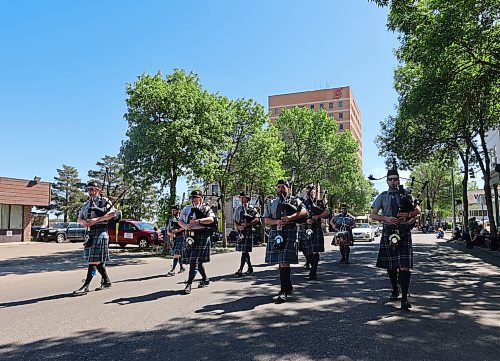 Bagpipers play while marching down Rosser. The parade is a musical affair, with marching bands and loudspeakers taking turns playing to the crowd. (Charlotte McConkey/The Brandon Sun)