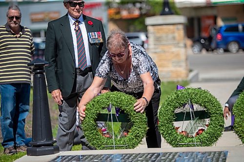 BROOK JONES / FREE PRESS
The Royal Winnipeg Rifles Association host an 80th D-Day anniversary ceremony at Vimy Ridge Park in Winnipeg, Man., Saturday, June 8, 2024. Pictured: Donna Reid, who is a niece of the late Sgt. James Allan (Jim) Reid, lays a wreath on behalf of veteran families during the commemoration ceremony as retired Maj.-Gen. Dennis Tabbernor, who is a former commanding officer of the RWR, looks on. Donna said Jim was captured by the Germans, along with two of his brothers. They were known as the Fighting Reids. Two brothers survived, but Jim was executed.