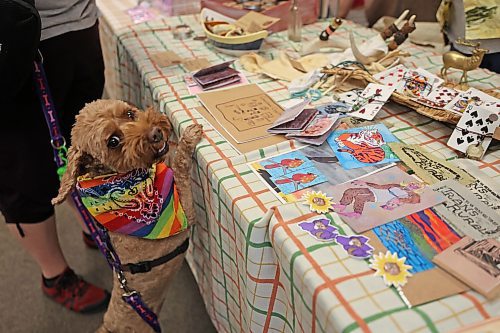 Lila got excited about mixed-media folk artist John Wesselius' work. (Charlotte McConkey/The Brandon Sun)