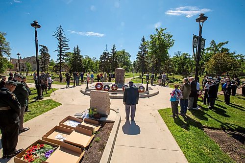 BROOK JONES / FREE PRESS
The Royal Winnipeg Rifles Association host an 80th D-Day anniversary ceremony at Vimy Ridge Park in Winnipeg, Man., Saturday, June 8, 2024. Pictured: People stand in silence as a member of the Royal Winnipeg Rifles Regimental Band plays the Last Post on a bugle during the commemoration ceremony.