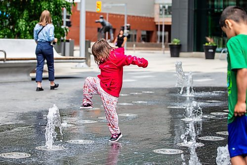 MIKAELA MACKENZIE / FREE PRESS

Three-year-old Jaylynn (no last name given) raises her foot to stomp on a stream of water at True North Square on Monday, June 10, 2024.

Standup.

