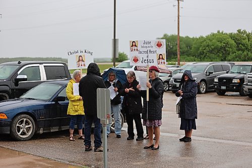 People holding religious signs stood outside the Mountain View School Division board office before Monday's board of trustees meeting. (Colin Slark/The Brandon Sun)