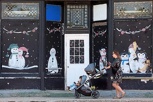 11062024
Pedestrians make their way past a winter scene painted on the facade of a building on Hartney&#x2019;s East Railway Street on Tuesday afternoon. 
(Tim Smith/The Brandon Sun)