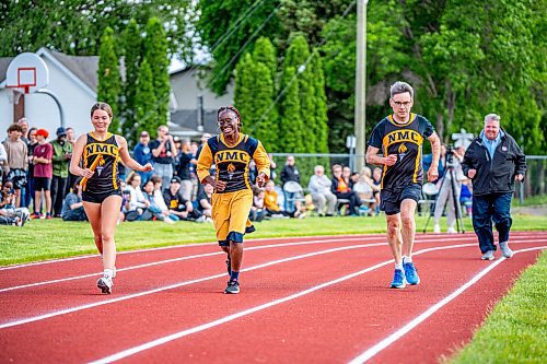 NIC ADAM / FREE PRESS

Coun. Brian Mayes runs on the newly opened track along with members of NMC&#x2019;s relay team at Nelson McIntyre Collegiate Tuesday afternoon

240611 - Tuesday, June 11, 2024.

Reporter: n/a