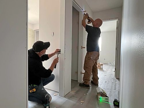 Cancade Restoration's Red Seal carpenters Barry Ewasiuk (left) and Jesse Greenwood are helping to finish two of Habitat for Humanity's Brandon duplexes on Franklin Street, part of the company's "gift in kind" to the non-profit organization. (Michele McDougall/The Brandon Sun) 