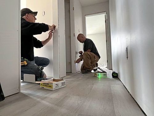 Cancade Restoration's Red Seal carpenters Barry Ewasiuk (left) and Jesse Greenwood are helping to finish two of Habitat for Humanity's Brandon duplexes on Franklin Street, part of the company's "gift in kind" to the non-profit organization. (Michele McDougall/The Brandon Sun) 