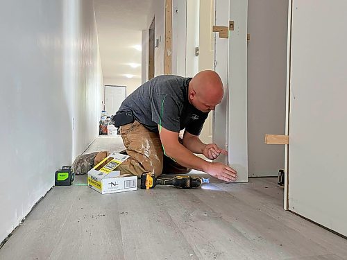 Cancade Restoration's Red Seal carpenter Jesse Greenwood checks the door jam on a closet in a Habitat for Humanity Brandon duplex on Franklin Street. (Michele McDougall/The Brandon Sun)