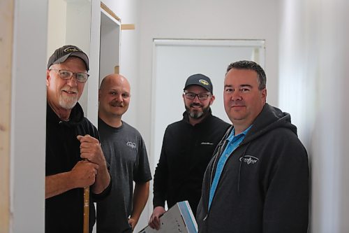 Cancade Restoration's red seal carpenters Barry Ewasiuk (from left) and Jesse Greenwood are helping to finish two of Habitat for Humanity's Brandon duplexes on Franklin Street, and stand next to Chad McNish and Cory Lawson, the company's partners, who describe the carpenters' time and expertise as a "gift in kind." (Michele McDougall/The Brandon Sun)