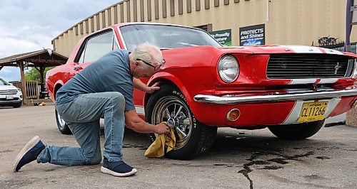 Westman's Layne Green polishes the rims on his 1966 Mustang GT Custom. (Michele McDougall/The Brandon Sun) 