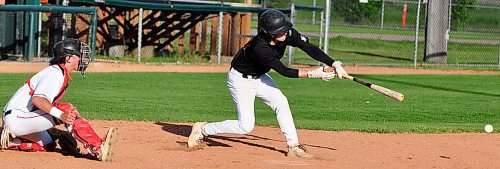 With Oildome catcher Griffin Albrecht looking on, Brandon Marlins batter Junior Martine hits an infield single during U18 AAA action Wednesday night at Andrews Field. Marlins edged Oildome 2-1. (Jules Xavier/The Brandon Sun)