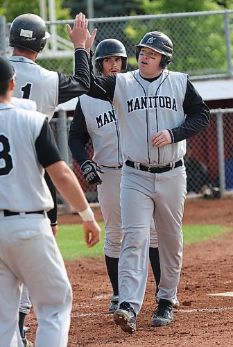 Bryan Swaenepoel of Manitoba is congratulated by teammates after hitting a home run during 2008 Senior Mens Championship action against Ontario 2 in Brandon. (Tim Smith/Brandon Sun)