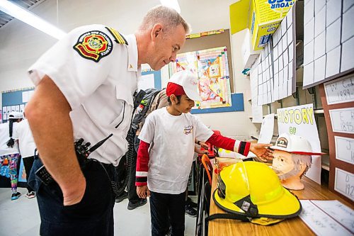 MIKAELA MACKENZIE / FREE PRESS

Meadows West School grade five student Gurpanth Dhillon presents his first responder art to platoon chief Chris Cauthers on Thursday, June 13, 2024.

For Matt story.

