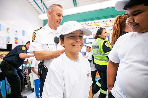 MIKAELA MACKENZIE / FREE PRESS

Meadows West School grade five student Tiago Benevides smiles as he gets his t-shirt signed by platoon chief Chris Cauthers as his class presents their first responder art show to first responders on Thursday, June 13, 2024.

For Matt story.

