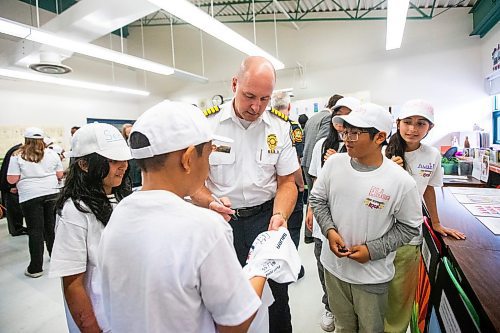 MIKAELA MACKENZIE / FREE PRESS

Fire and paramedic chief Christian Schmidt signs Meadows West School grade five students&#x560;t-shirts as they present their first responder art show to first responders on Thursday, June 13, 2024.

For Matt story.

