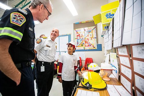 MIKAELA MACKENZIE / FREE PRESS

Meadows West School grade five student Gurpanth Dhillon presents his first responder art to Patrick McInnis, advanced care paramedic, and Christian Schmidt, fire and paramedic chief, on Thursday, June 13, 2024.

For Matt story.

