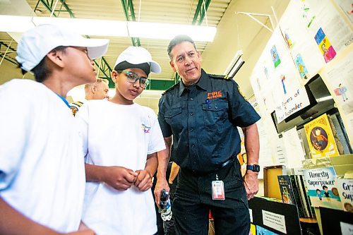 MIKAELA MACKENZIE / FREE PRESS

Meadows West School grade five students Colin Ablaza (left) and Brahmdeep Singh present their first responder art to Doug Sinclair, public education coordinator for the WFPS, on Thursday, June 13, 2024.

For Matt story.

