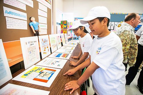 MIKAELA MACKENZIE / FREE PRESS

Meadows West School grade five students Noor Randhawa (left) and Jared Sananikone present their first responder art show to first responders on Thursday, June 13, 2024.

For Matt story.

