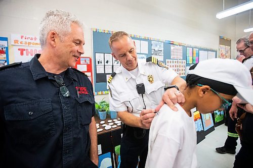 MIKAELA MACKENZIE / FREE PRESS

Platoon chief Chris Cauthers signs Meadows West School grade five students&#x560;t-shirts as they present their first responder art show to first responders on Thursday, June 13, 2024.

For Matt story.

