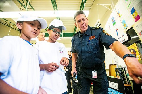 MIKAELA MACKENZIE / FREE PRESS

Meadows West School grade five students Colin Ablaza (left) and Brahmdeep Singh present their first responder art to Doug Sinclair, public education coordinator for the WFPS, on Thursday, June 13, 2024.

For Matt story.

