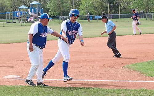 Riley Shamray of the Oak River Dodgers slaps hands with his father, coach Derek Shamray, as he rounds third base following his home run in a 7-2 victory in Oak River to win the Western Canadian senior AA championship last summer in Oak River. The elder Shamray has earned a spot in the Manitoba Baseball Hall of Fame for his work on and off the baseball diamond. (Perry Bergson/The Brandon Sun)
