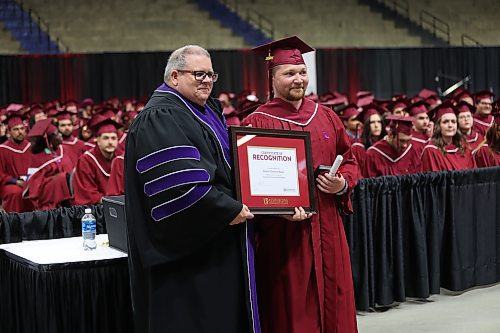 Assiniboine College president Mark Frison (left) presents Lieutenant Governor’s Silver Medal award winner Dustin Bauer with an award for outstanding academic performance during Friday morning's convocation ceremony at Westoba Place. (Abiola Odutola/The Brandon Sun) 