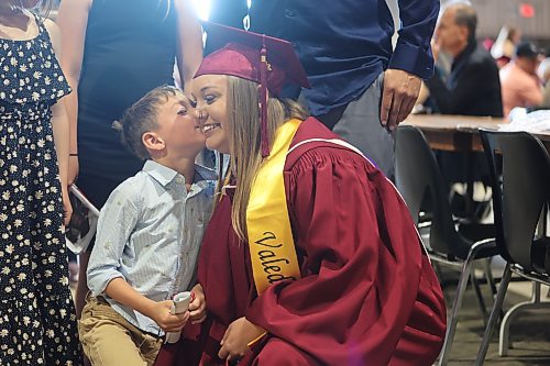 Valedictorian Alycia Canada gets a kiss from her son, Thomas, 6, during Assiniboine College's convocation ceremony on Friday morning. See story on Page A3. (Abiola Odutola/The Brandon Sun)