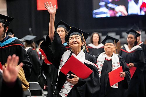 MIKAELA MACKENZIE / FREE PRESS

U of W&#x573; Developmental Studies program graduate Victoria Antsanen waves while leaving the graduation ceremony on Friday, June 14, 2024. 

For Jura story.

