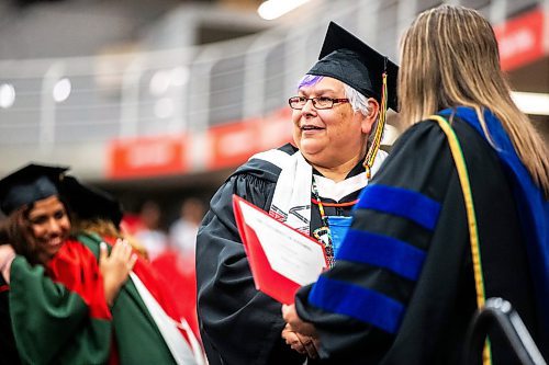 MIKAELA MACKENZIE / FREE PRESS

U of W&#x573; Developmental Studies program graduate Vivian Scott poses for a photo with dean of education Laurie-Ann Hellsten while crossing the stage on Friday, June 14, 2024. 

For Jura story.

