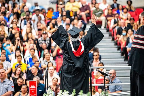 MIKAELA MACKENZIE / FREE PRESS

U of W&#x573; Developmental Studies program graduate Vivian Scott raises her arms in response to cheers while crossing the stage on Friday, June 14, 2024. 

For Jura story.

