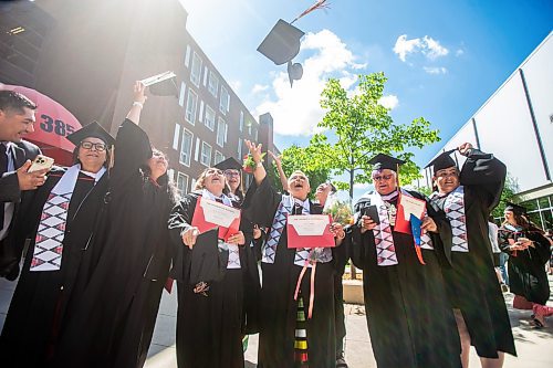 MIKAELA MACKENZIE / FREE PRESS

U of W&#x573; Developmental Studies program graduates throw their caps for a group photo after their graduation ceremony on Friday, June 14, 2024. 

For Jura story.

