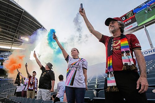 Daniel Crump / Winnipeg Free Press. Fans from the Valour supporter group, Red River Rising, hold smoke flares in the colour of a rainbow to celebrate pride night. Valour FC take on Pacific FC in the last of a three game homestead at Winnipeg Stadium Friday night. June 14, 2024.