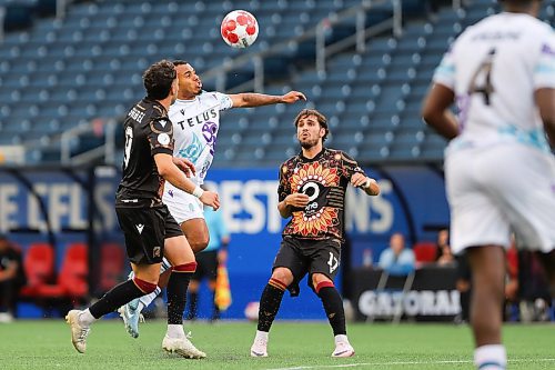 Daniel Crump / Winnipeg Free Press. Valour&#x573; Jordan Swibel (9) jockeys for the ball with a Pacific player. Valour FC take on Pacific FC in the last of a three game homestead at Winnipeg Stadium Friday night. June 14, 2024.