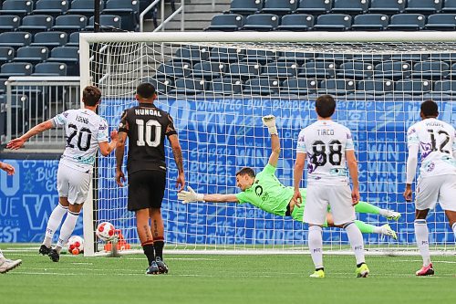 Daniel Crump / Winnipeg Free Press. Pacific&#x573; Sean Young (20) puts one past Valour goalkeeper Johnathan Viscosi (50) from the penalty spot. Valour FC take on Pacific FC in the last of a three game homestead at Winnipeg Stadium Friday night. June 14, 2024.