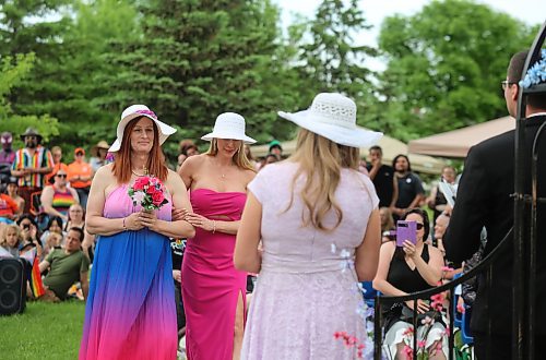 Wendy Friesen walks down the aisle towards her bride-to-be Anastasia Jane Gibson at their wedding held during Pride celebrations at Rideau Park on Saturday. (Colin Slark/The Brandon Sun)