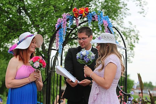 Anastasia Jane Gibson reads her personally-written vows to bride Wendy Friesen at their wedding held during Pride celebrations at Rideau Park on Saturday. (Colin Slark/The Brandon Sun)